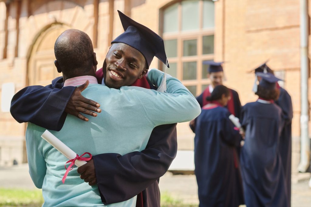 Father congratulating his son with graduation