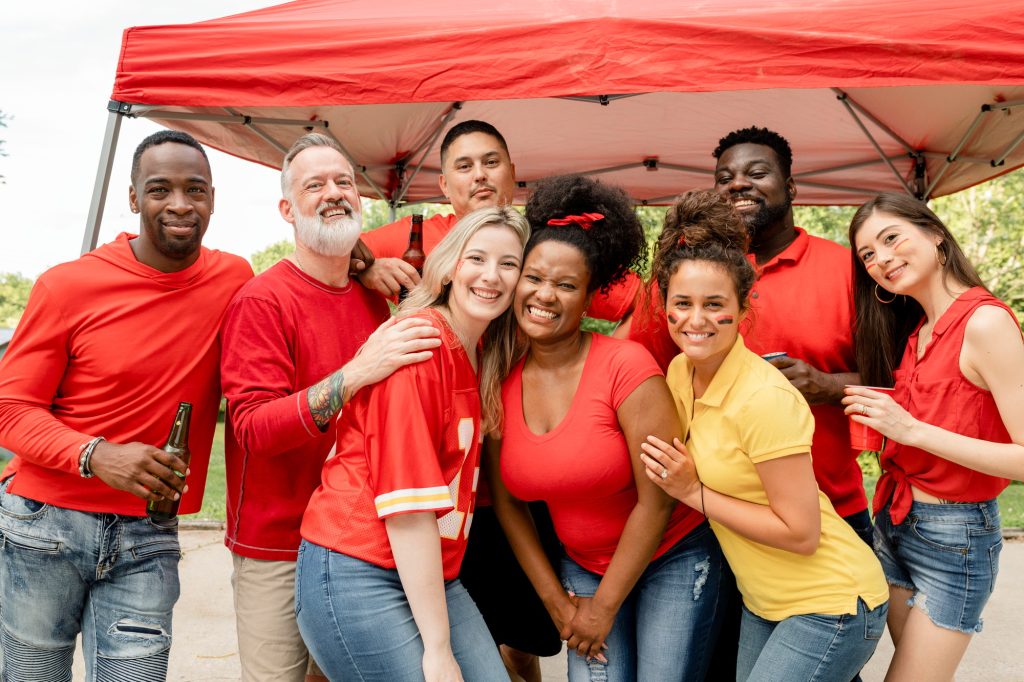 Friends celebrating at a tailgate sports party
